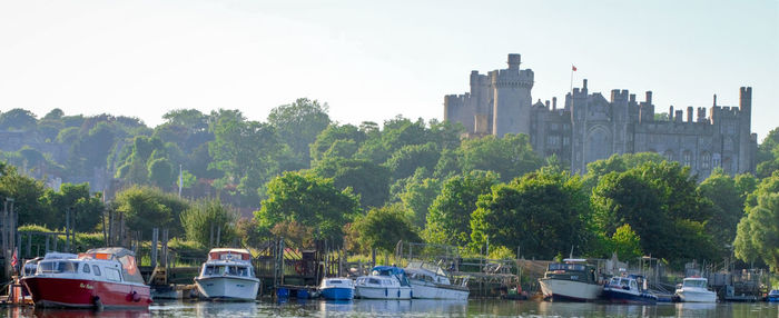 View of boats moored at riverbank