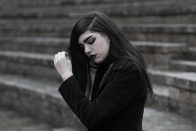 Young woman looking away outdoors