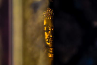 Close-up of lit candles in temple