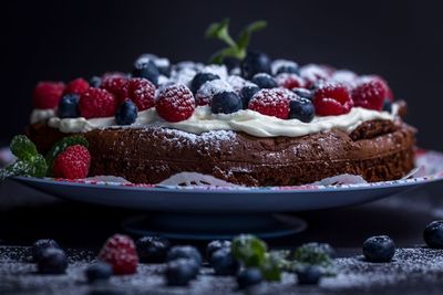 Close-up of berry fruits on sweet food in plate