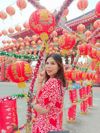 Portrait of smiling young woman standing on street