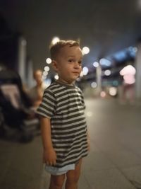 Rear view of woman standing at night