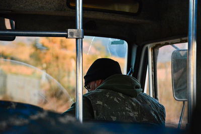 Rear view of man sitting in train