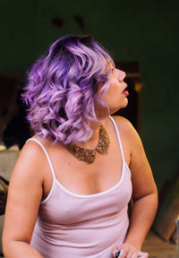 Woman with dyed hair looking away