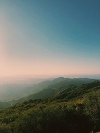 Scenic view of landscape against clear sky during sunset