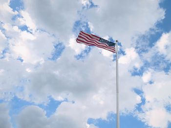 Low angle view of us flag against sky