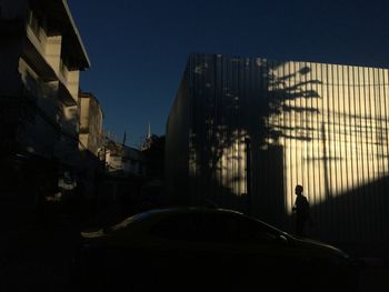 Silhouette city buildings against clear sky