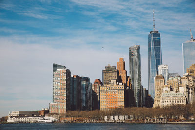 View of skyscrapers against cloudy sky