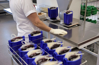 Midsection of man preparing food in workshop