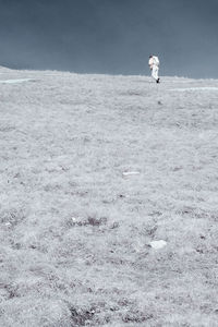 Side view of woman standing on landscape