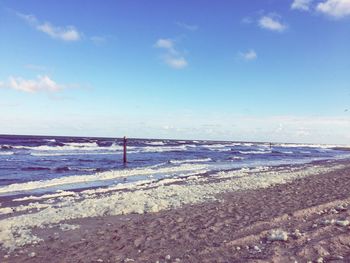 Scenic view of sea against cloudy sky