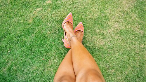 Low section of woman relaxing on grass