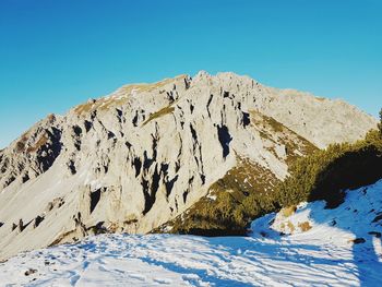 Scenic view of snowcapped mountains against clear blue sky