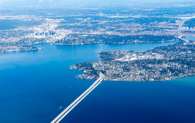 High angle view of sea and cityscape against sky