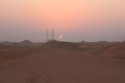 Scenic view of desert against sky during sunset