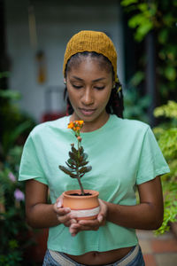 Portrait of girl holding plant