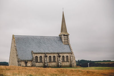 Church on field against sky