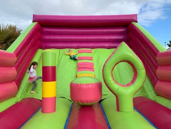 Siblings playing on bouncy castle