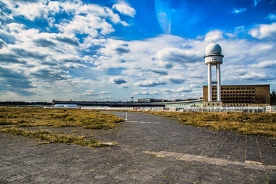 The abandoned tempelhof airfield i berlin, germany against a cloudy summer sky