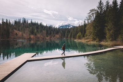 Person walking on pier at caumasee lake