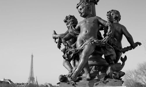 Low angle view of statue against sky in city