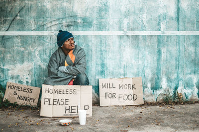 Woman with text written on paper outdoors