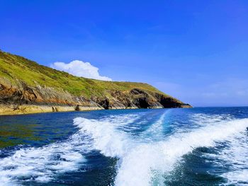 Scenic view of sea against blue sky