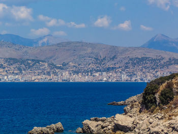 Scenic view of sea and mountains against sky