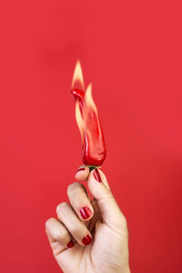 Close-up of human hand against red background