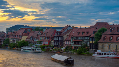 Boats in river with buildings in background