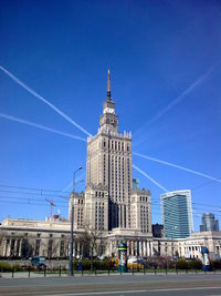 Low angle view of tall building against blue sky