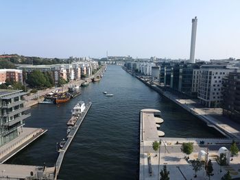 High angle view of river amidst buildings in city against sky