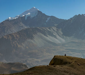 Scenic view of snowcapped mountain against blue sky