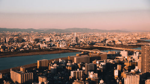 High angle view of illuminated city buildings against sky