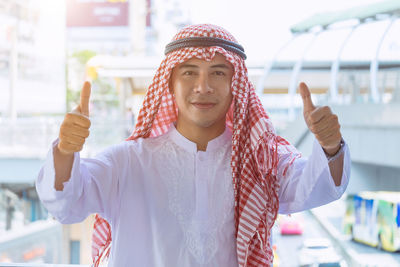 Portrait of young man wearing hat standing outdoors