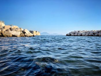 Scenic view of sea against clear blue sky