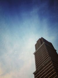 Low angle view of building against cloudy sky