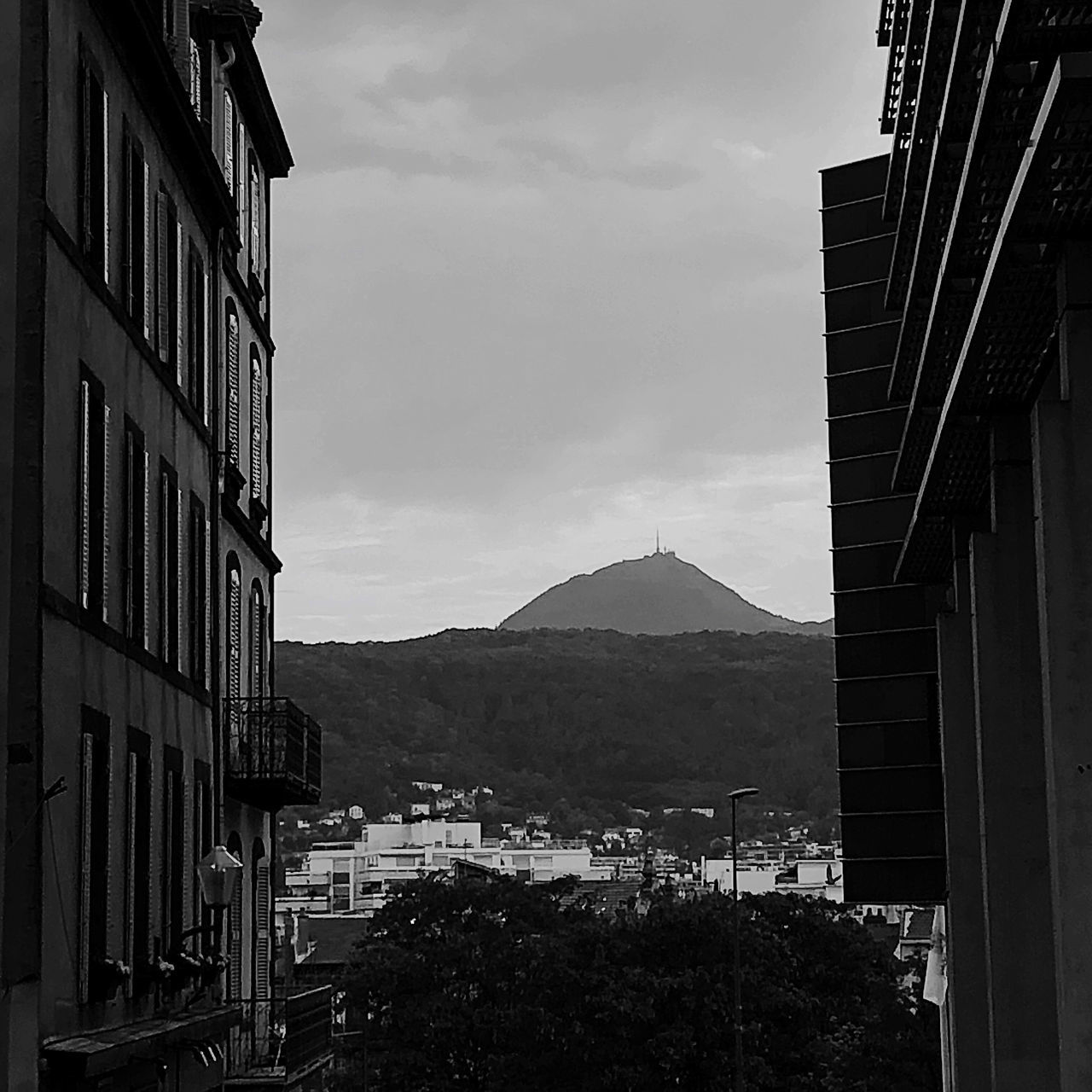 architecture, black and white, black, monochrome, building exterior, built structure, monochrome photography, sky, building, city, mountain, urban area, no people, nature, white, cloud, darkness, house, road, outdoors, day, residential district, street