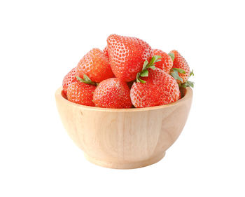 Close-up of strawberries in bowl against white background