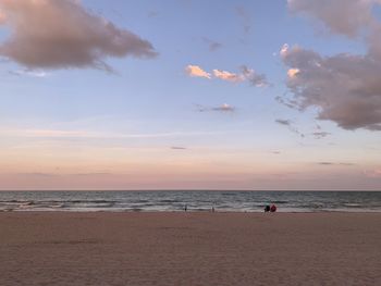 Scenic view of beach against sky during sunset