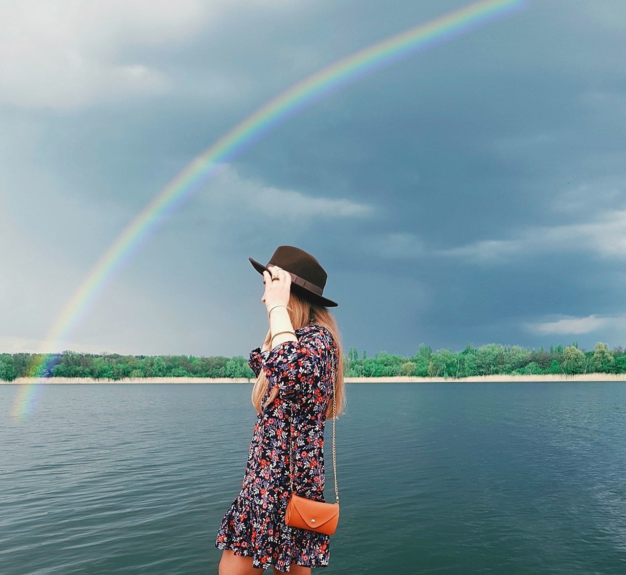 water, scenics - nature, sky, cloud - sky, beauty in nature, rainbow, one person, lifestyles, day, leisure activity, real people, women, nature, standing, clothing, hat, non-urban scene, three quarter length, outdoors, double rainbow