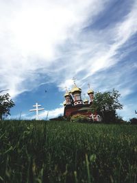 Traditional windmill on field against sky