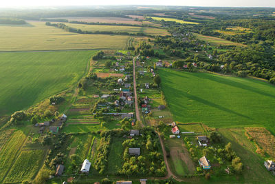 Country houses in the countryside. aerial view of roofs of green field with rural homes.