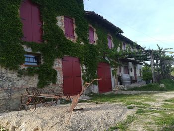 Old houses in village by buildings in town