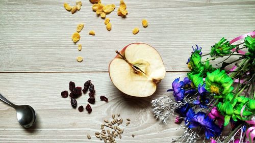 High angle view of flowers and fruits on table