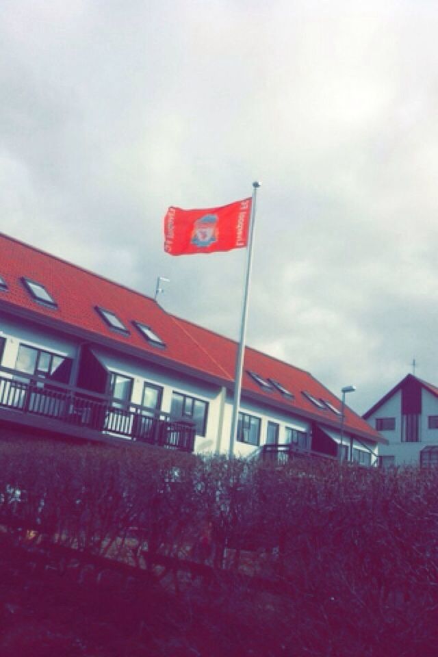 architecture, building exterior, built structure, red, sky, low angle view, cloud - sky, flag, identity, patriotism, cloud, house, day, national flag, cloudy, outdoors, no people, residential structure, building, american flag