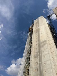 Low angle view of building against cloudy sky