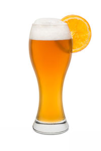 Close-up of beer glass against white background