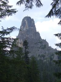 Low angle view of rocky mountains against sky