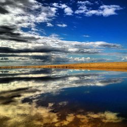 Scenic view of sea against cloudy sky